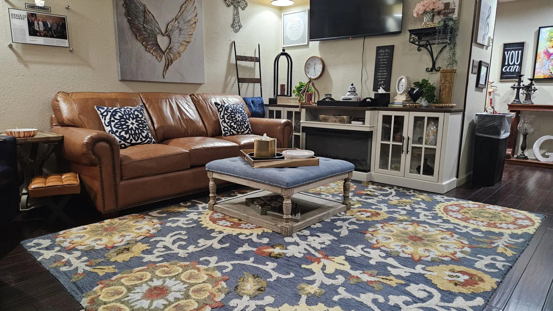 A lounge with a leather sofa and a hand-painted winged heart